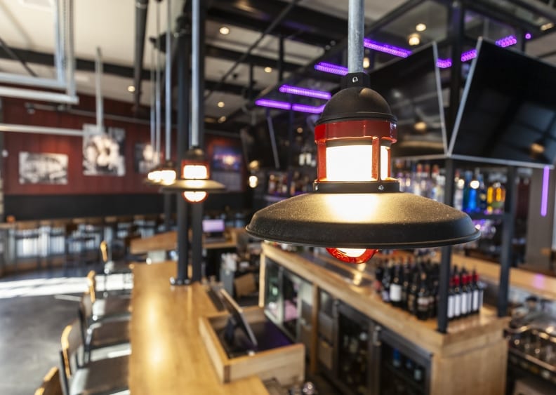 Photo depicting architectural pendant lighting and LED lighting for liquor bottle displays