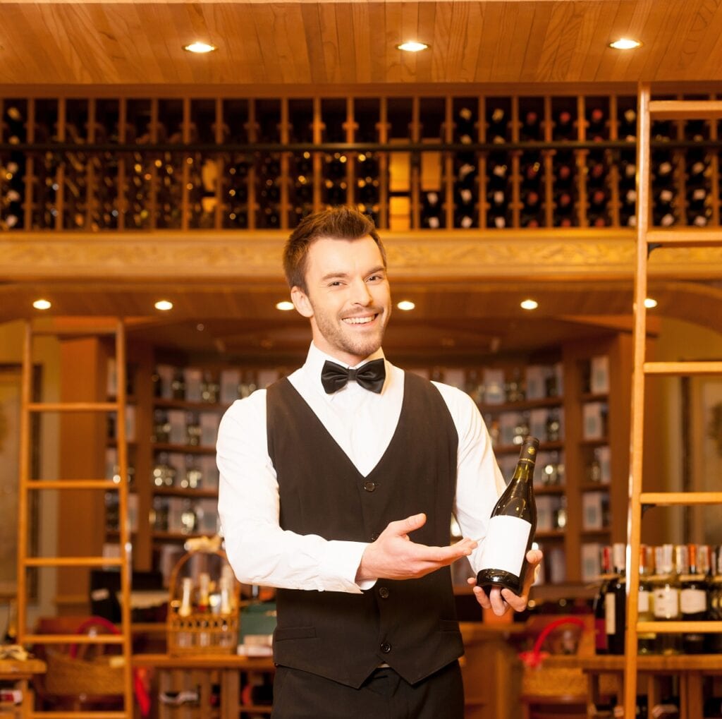 Photo of wine steward with a rolling ladder