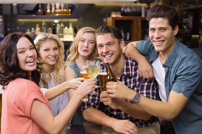 Photo of happy bar customers sharing a drink