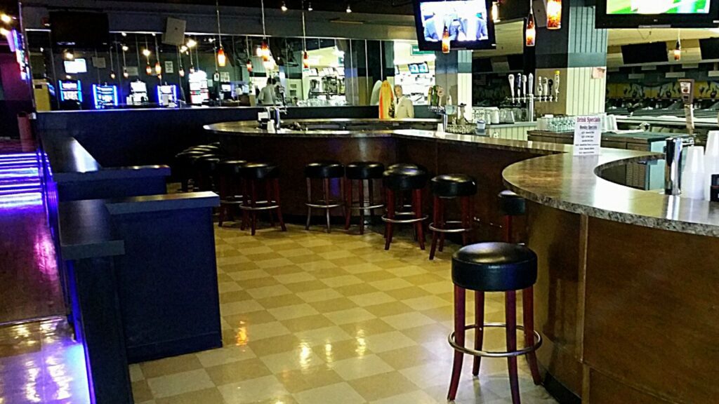 Photo of large island bar and back bar before redesign