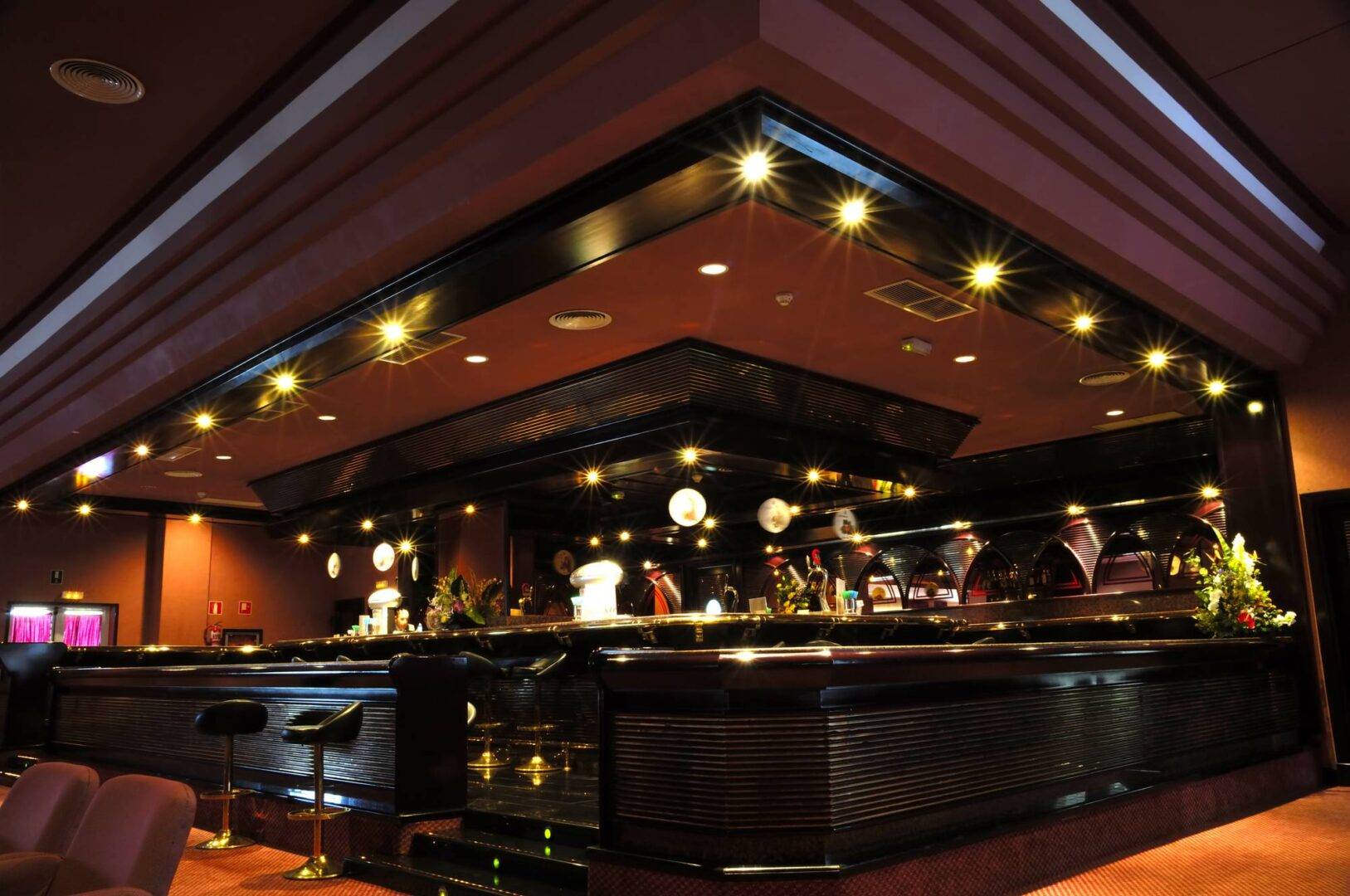 Photo of luxury bar by Cabaret Design Group with architectural bar design